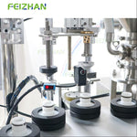Automated packing machine with positioning mechanical components and Feizhan branding.